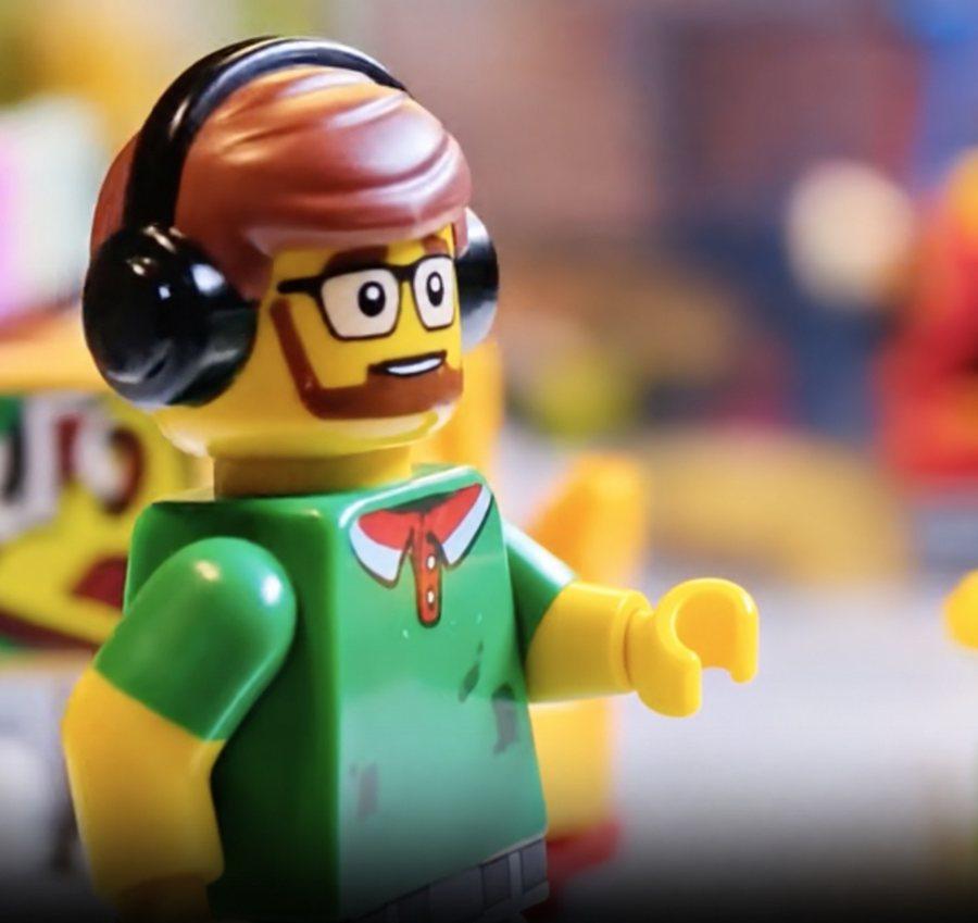 Close-up photo of Lil' G, a minifig with headphones and glasses